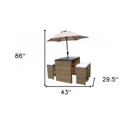 Six Piece Brown and White Faux Wicker Outdoor Bar Height Table Set with Umbrella and Stools